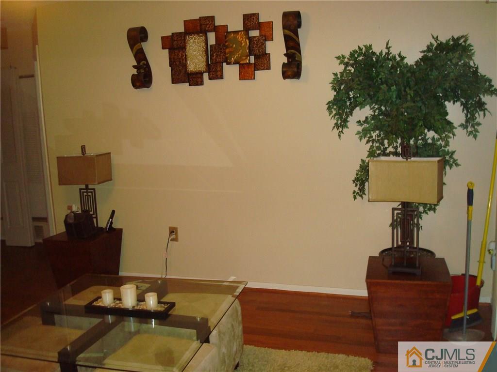 317 Edpas Road, Unit 317 New Brunswick, NJ 08901 - Photo 6 of 9 a living room with furniture and a lamp