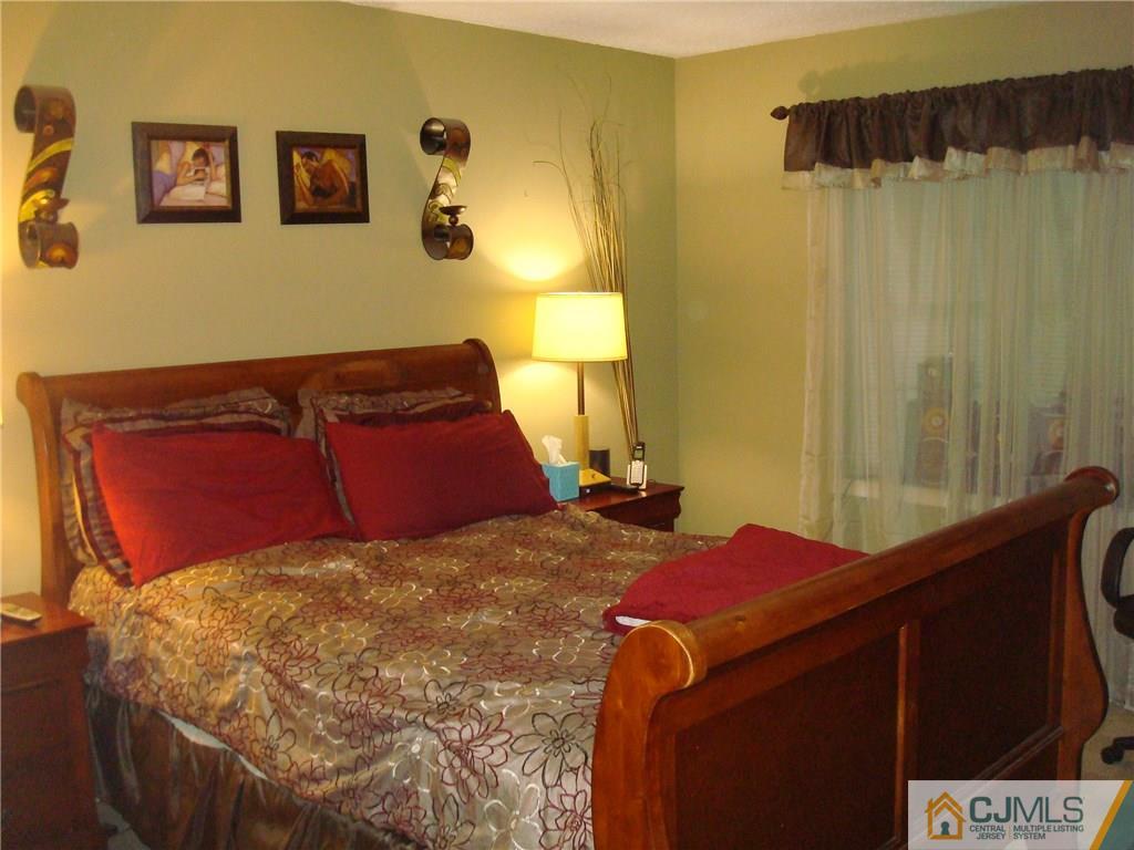 317 Edpas Road, Unit 317 New Brunswick, NJ 08901 - Photo 9 of 9 a bedroom with a bed and a dresser