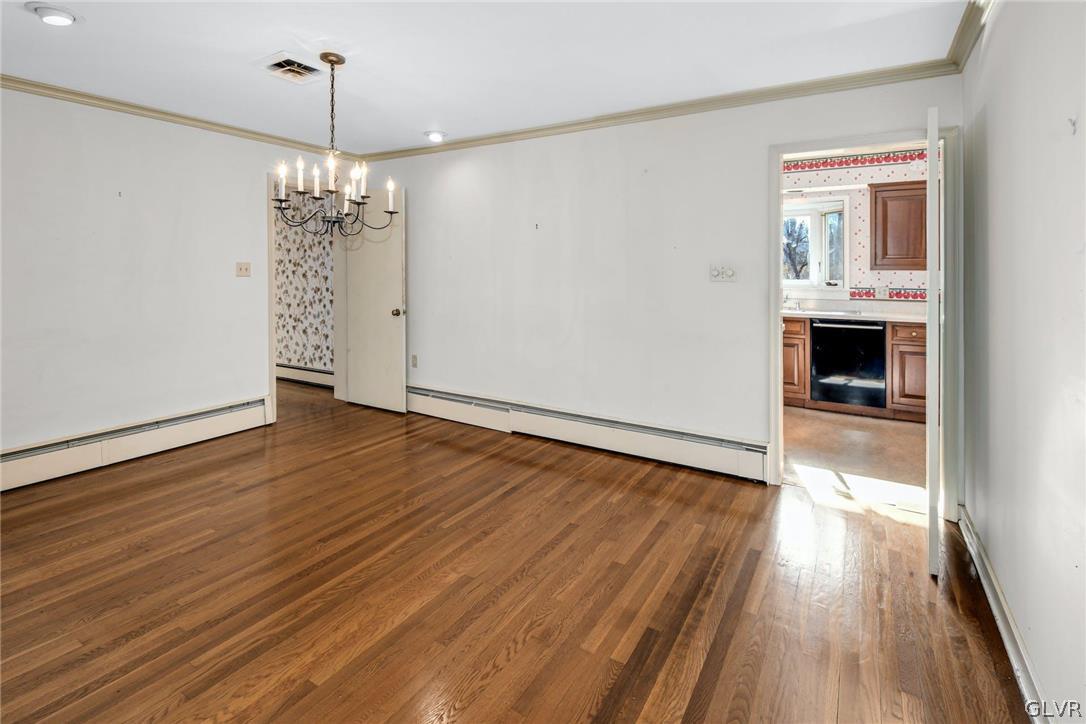 1655 White Acre Drive Bethlehem, PA 18015 - Photo 11 of 39 a view of a room with wooden floor a ceiling fan and kitchen space