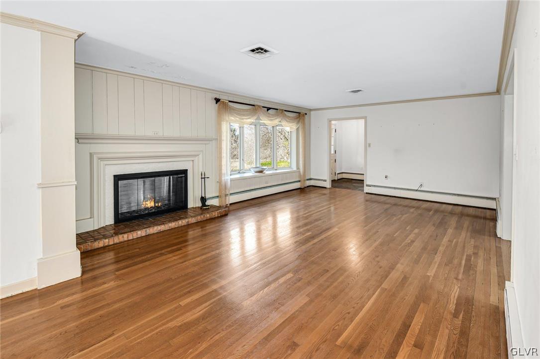 1655 White Acre Drive Bethlehem, PA 18015 - Photo 8 of 39 an empty room with wooden floor fireplace and windows