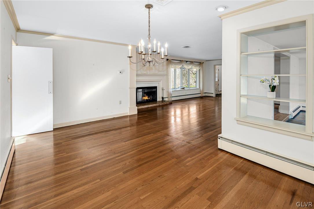 1655 White Acre Drive Bethlehem, PA 18015 - Photo 10 of 39 a view of a livingroom with wooden floor a fireplace and windows