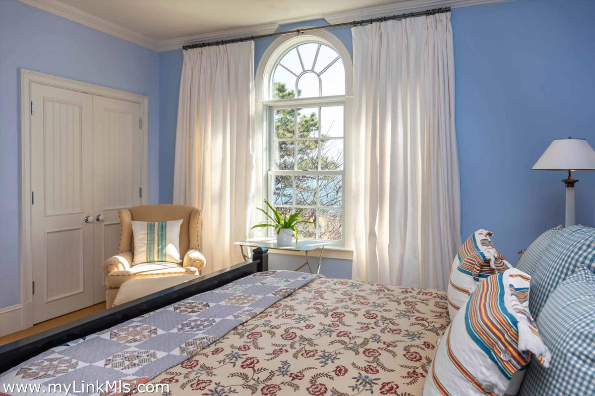 25 Lelands Path Edgartown, MA 02539 - Photo 49 of 56 a bedroom with a bed and wooden floor