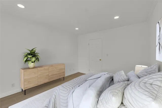 a bedroom with a bed and a potted plant