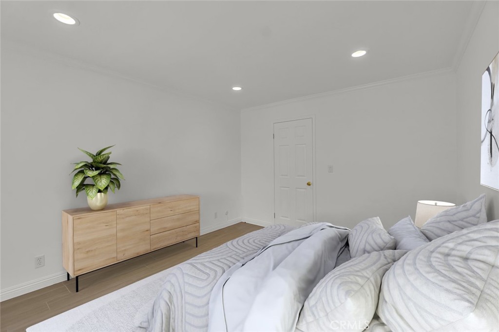 200 McNeil Lane, Unit 204 Newport Beach, CA 92663 - Photo 11 of 28 a bedroom with a bed and a potted plant