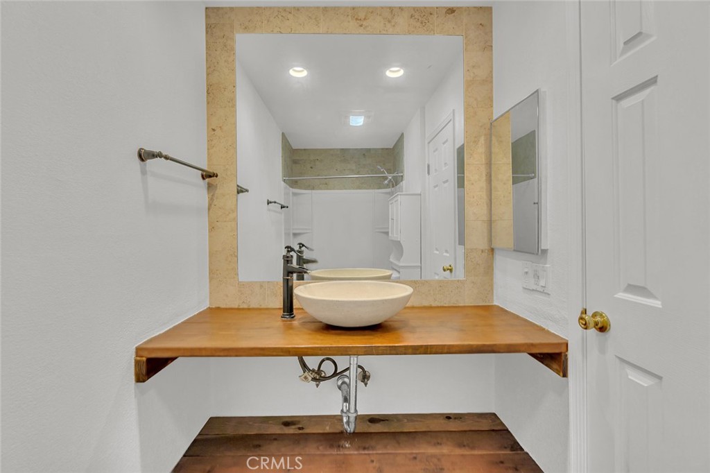 200 McNeil Lane, Unit 204 Newport Beach, CA 92663 - Photo 13 of 28 a bathroom with a sink and a mirror
