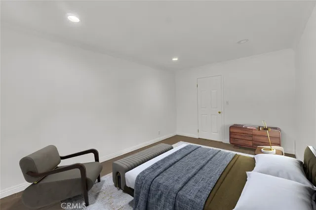 a bedroom with a bed and a chair