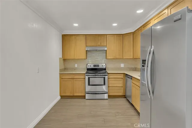 a kitchen with a refrigerator and a stove