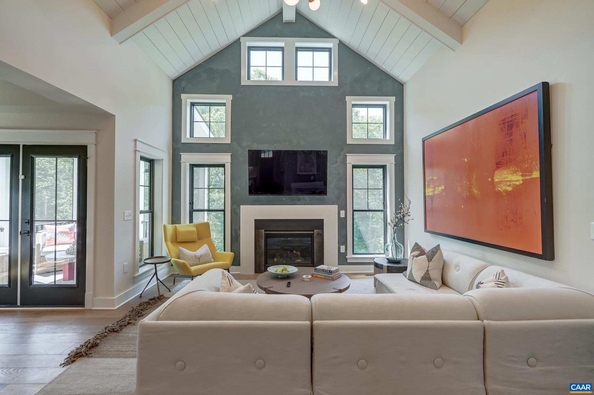 3327 Rowcross Street Crozet, VA 22932 - Photo 18 of 63 a living room with furniture a flat screen tv and a fireplace