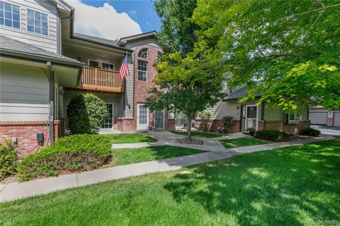 a view of a house with a yard and sitting area