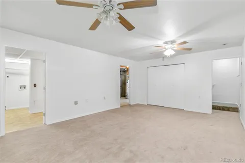 an empty room with fan and a ceiling fan