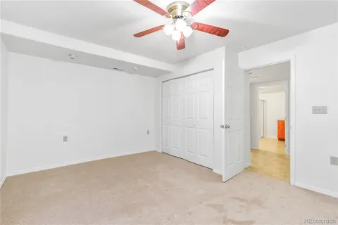 a view of a room with a ceiling fan and a bathroom