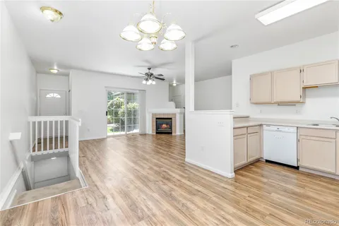 a kitchen with a white cabinets stove and wooden floor