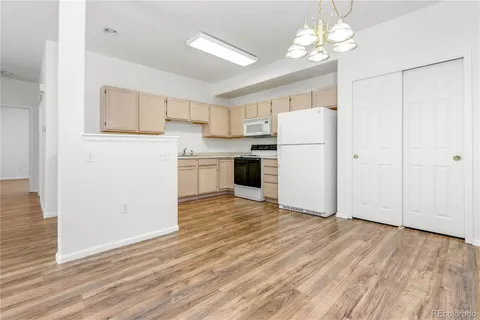 a view of a kitchen with a sink and a refrigerator