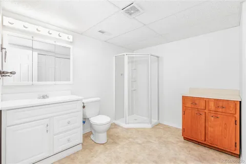 a bathroom with a toilet sink and a mirror