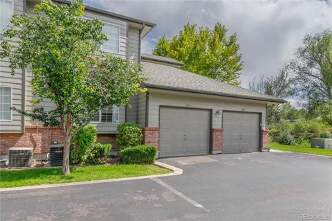 a view of a house with a yard and garage