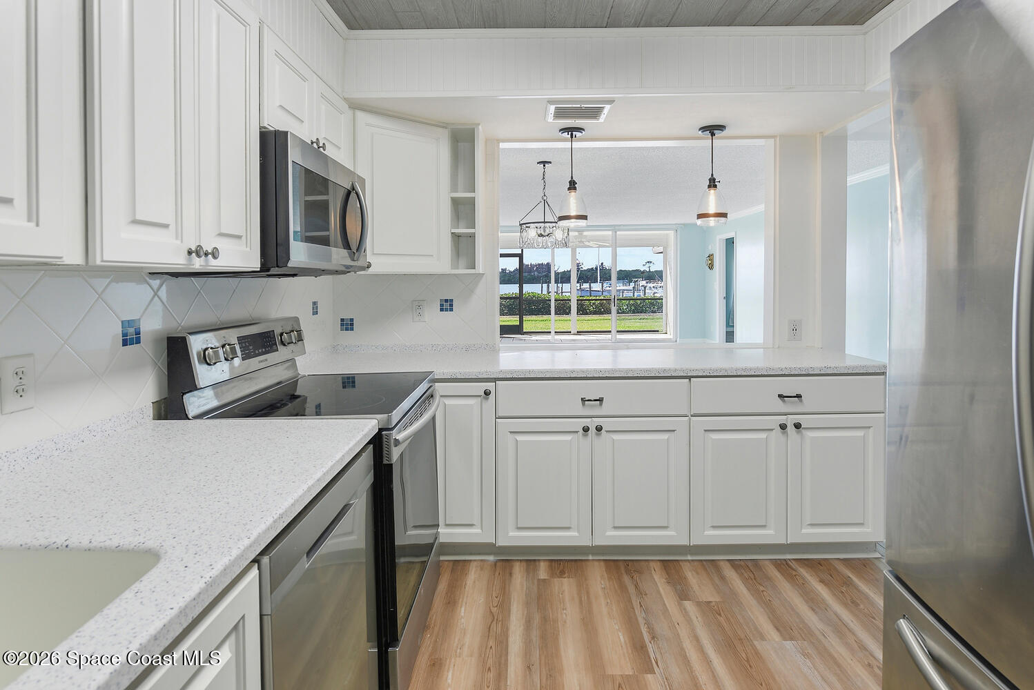 3100 Southeast Pruitt Road, Unit 104 Port St. Lucie, FL 34952 - Photo 13 of 32 a kitchen with cabinets and window
