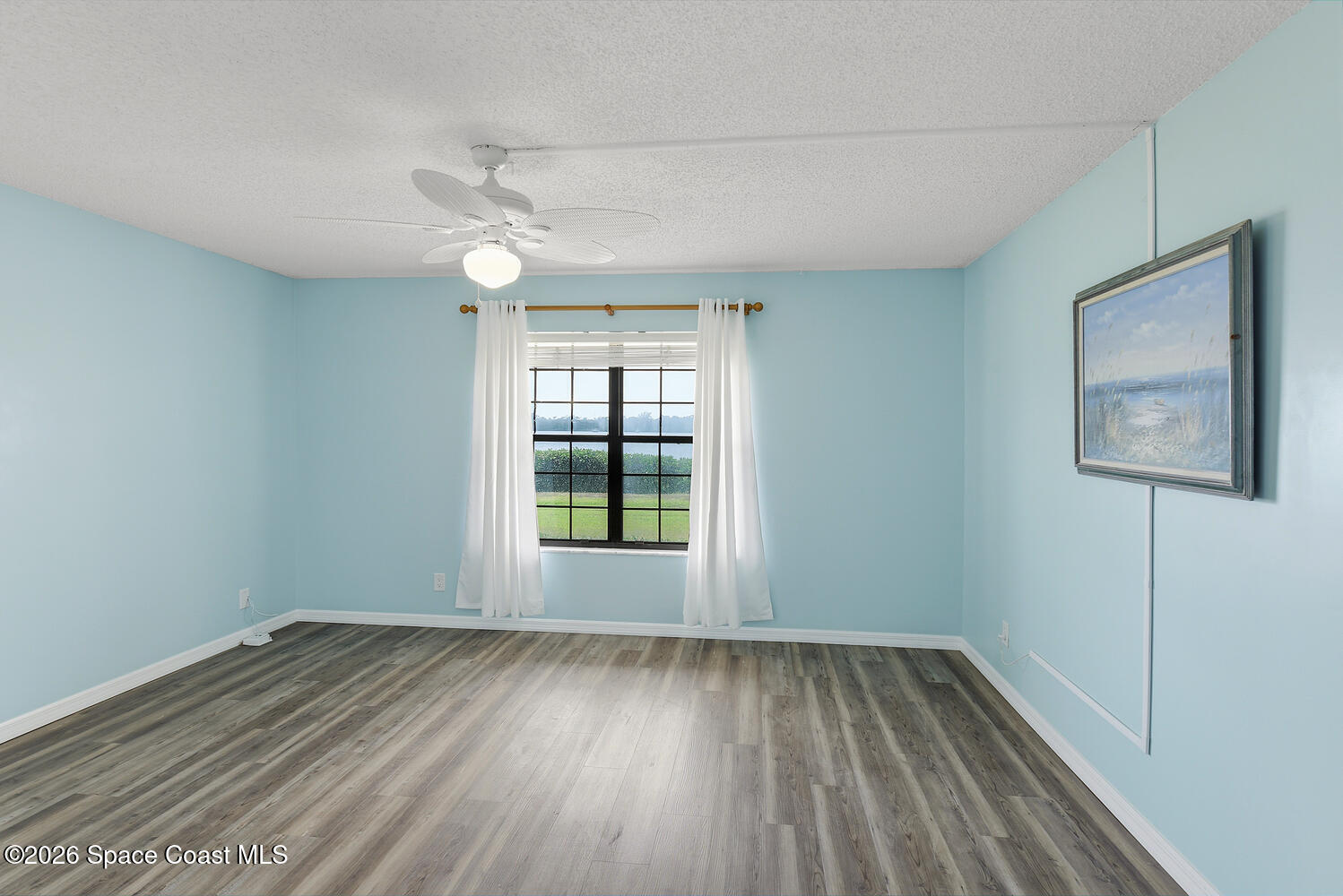 3100 Southeast Pruitt Road, Unit 104 Port St. Lucie, FL 34952 - Photo 16 of 32 wooden floor in an empty room with a window