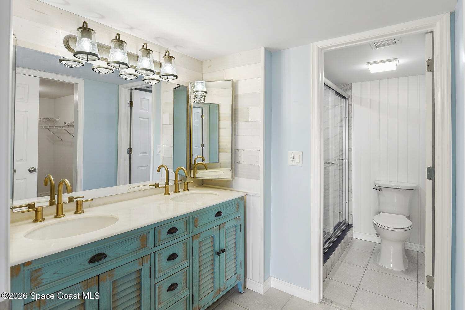 3100 Southeast Pruitt Road, Unit 104 Port St. Lucie, FL 34952 - Photo 18 of 32 a bathroom with a double vanity sink mirror and toilet
