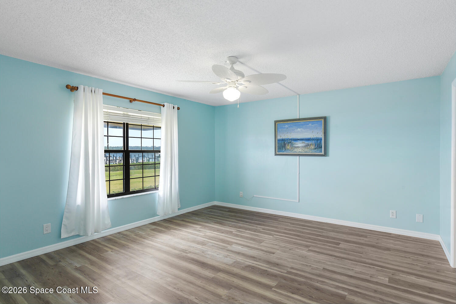 3100 Southeast Pruitt Road, Unit 104 Port St. Lucie, FL 34952 - Photo 20 of 32 a view of an empty room with a window and wooden floor