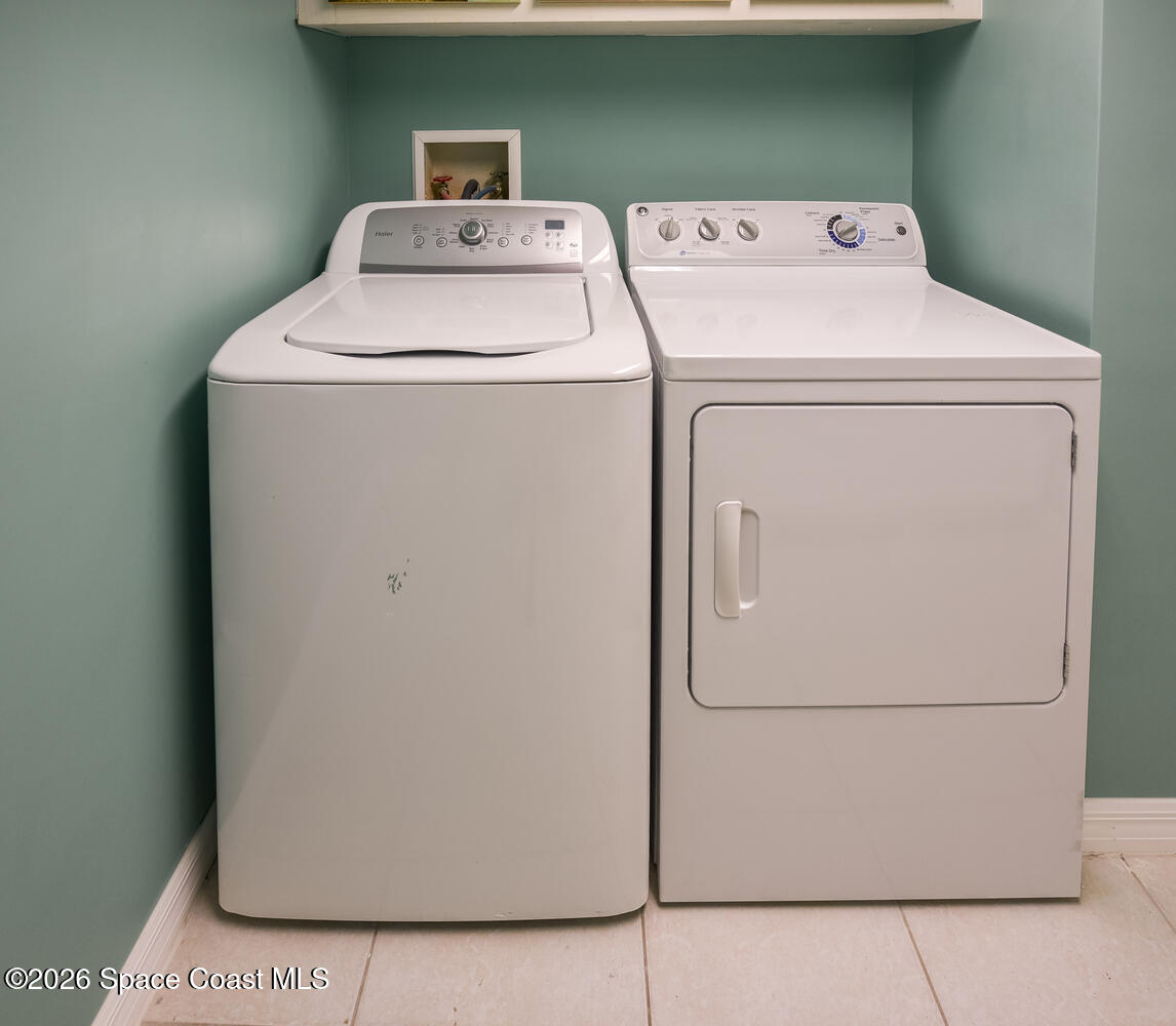 3100 Southeast Pruitt Road, Unit 104 Port St. Lucie, FL 34952 - Photo 22 of 32 a utility room with dryer and washer