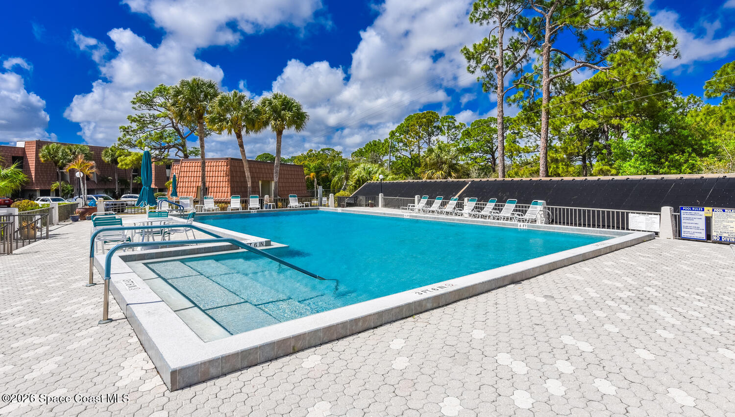 3100 Southeast Pruitt Road, Unit 104 Port St. Lucie, FL 34952 - Photo 30 of 32 a view of a swimming pool with a patio
