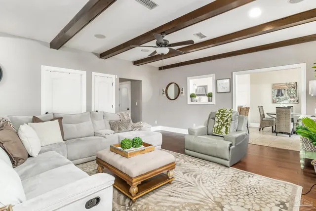 a living room with furniture and wooden floor