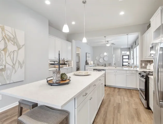 a bedroom with a bed a chandelier and a couch