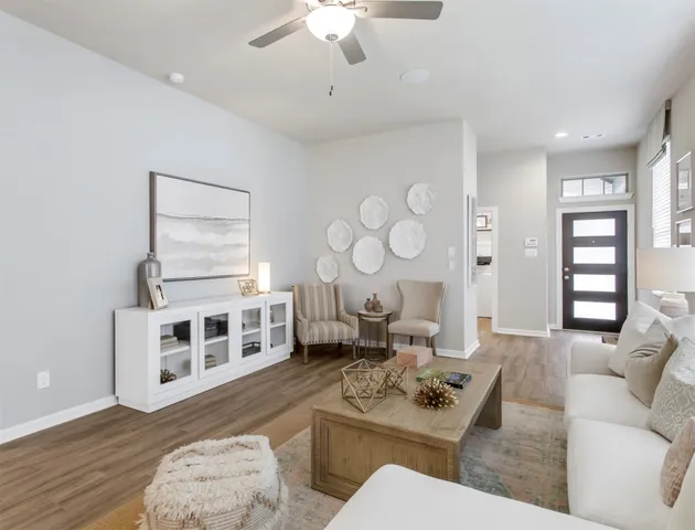 a kitchen with stainless steel appliances kitchen island granite countertop a table chairs and a refrigerator