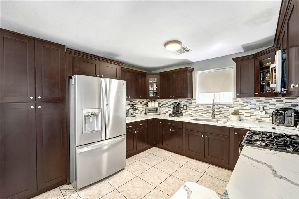 13250 Mercer Street Pacoima, CA 91331 - Photo 1 of 1 a kitchen with granite countertop a refrigerator and a sink