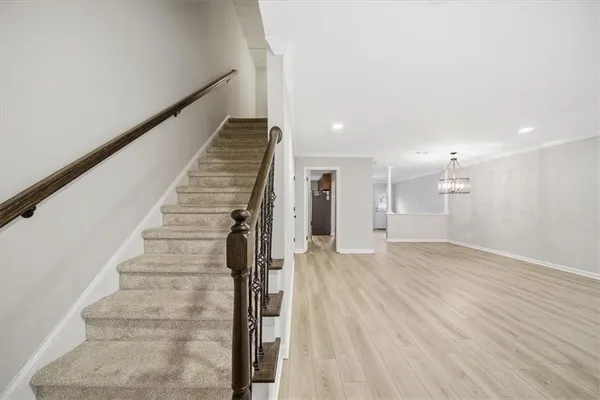 a view of entryway and hall with wooden floor