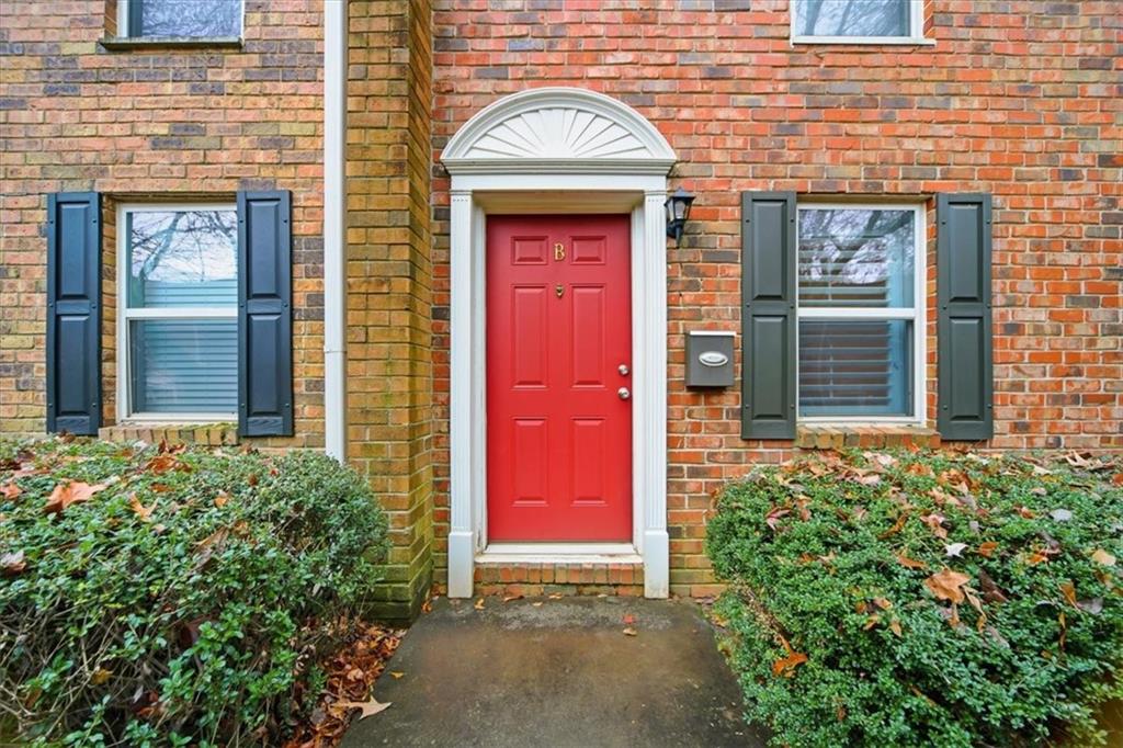 115 Winding River Drive, Unit B Atlanta, GA 30350 - Photo 2 of 32 front view of a brick house with a large door