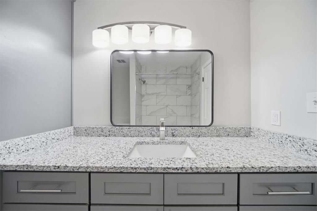 115 Winding River Drive, Unit B Atlanta, GA 30350 - Photo 21 of 32 a bathroom with a granite countertop sink and vanity