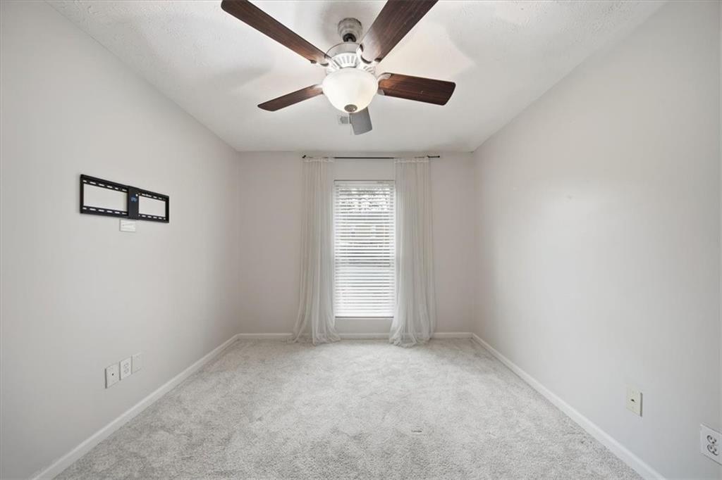 115 Winding River Drive, Unit B Atlanta, GA 30350 - Photo 23 of 32 an empty room with windows and ceiling fan