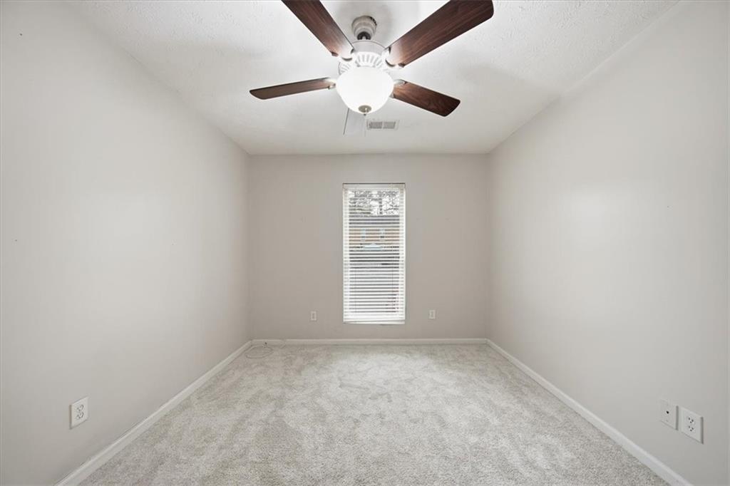 115 Winding River Drive, Unit B Atlanta, GA 30350 - Photo 25 of 32 an empty room with a window and a ceiling fan