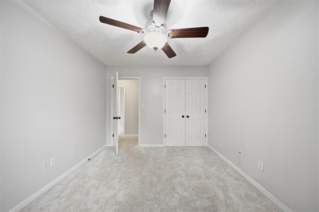 115 Winding River Drive, Unit B Atlanta, GA 30350 - Photo 26 of 32 an empty room with chandelier fan