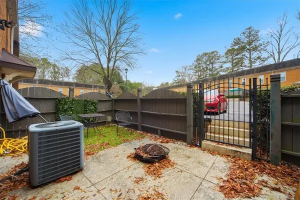 a view of a backyard with a large tree and a yard