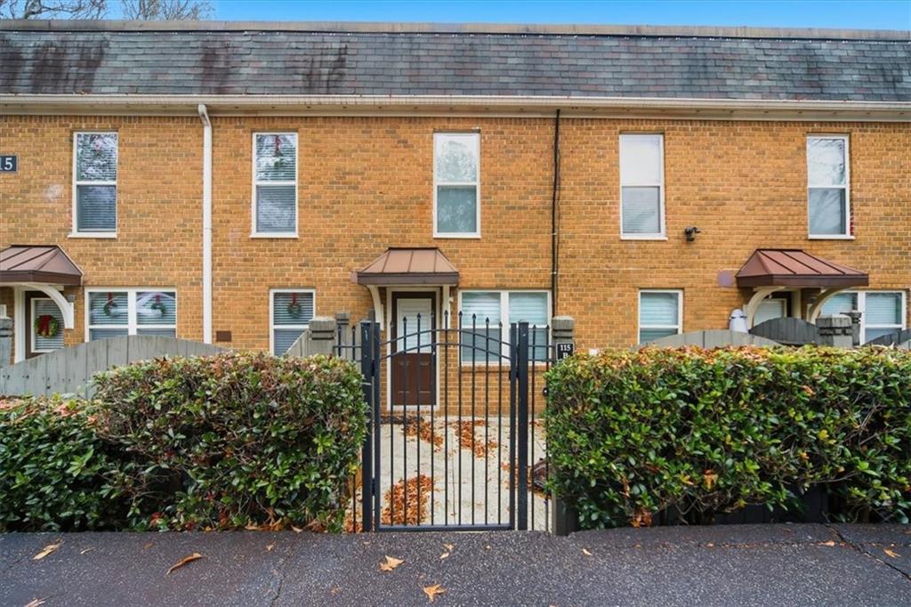 115 Winding River Drive, Unit B Atlanta, GA 30350 - Photo 30 of 32 front view of a brick house with a large window
