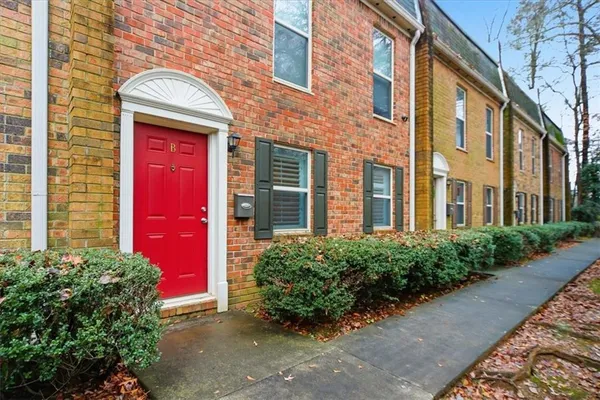 front view of a brick house with a yard