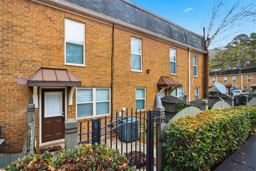 115 Winding River Drive, Unit B Atlanta, GA 30350 - Photo 31 of 32 a front view of a house with outdoor seating and plants
