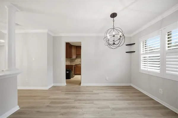 a big room with wooden floor and windows