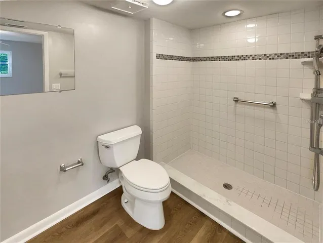 a bathroom with a sink toilet and mirror