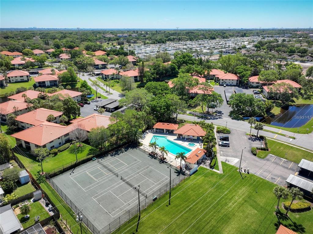 1003 Hammock Pine Boulevard, Unit 1003 Clearwater, FL 33761 - Photo 2 of 28 an aerial view of a house with a garden and lake view
