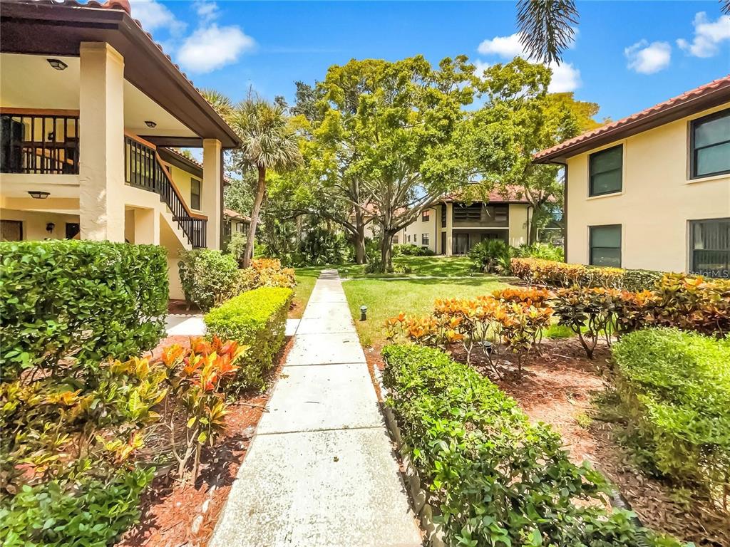 1003 Hammock Pine Boulevard, Unit 1003 Clearwater, FL 33761 - Photo 22 of 28 a front view of a house with a yard