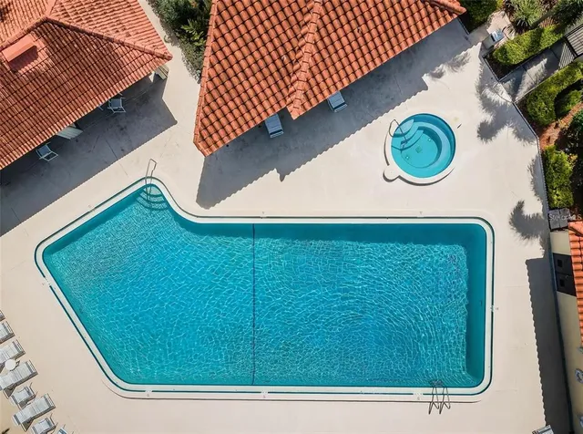 an aerial view of a house with a yard and lake view