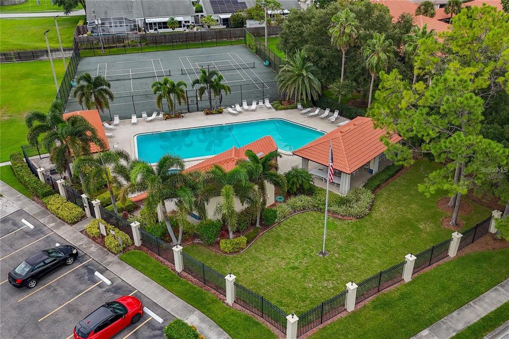 1003 Hammock Pine Boulevard, Unit 1003 Clearwater, FL 33761 - Photo 25 of 28 an aerial view of a house with a yard and lake view
