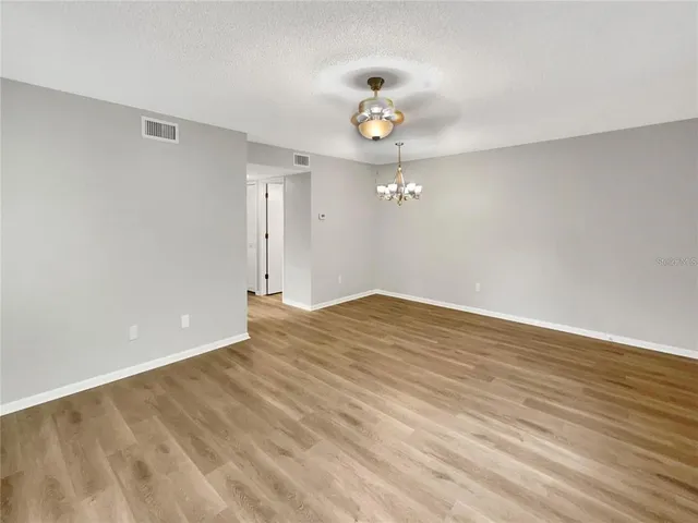 a view of a kitchen with a sink and dishwasher wooden floor