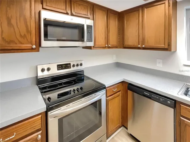 a kitchen with stainless steel appliances granite countertop a refrigerator sink and cabinets