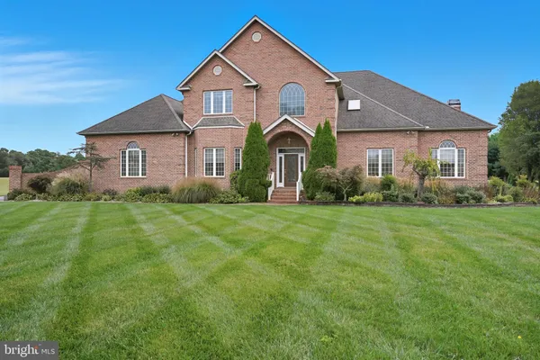 a front view of house with yard and green space