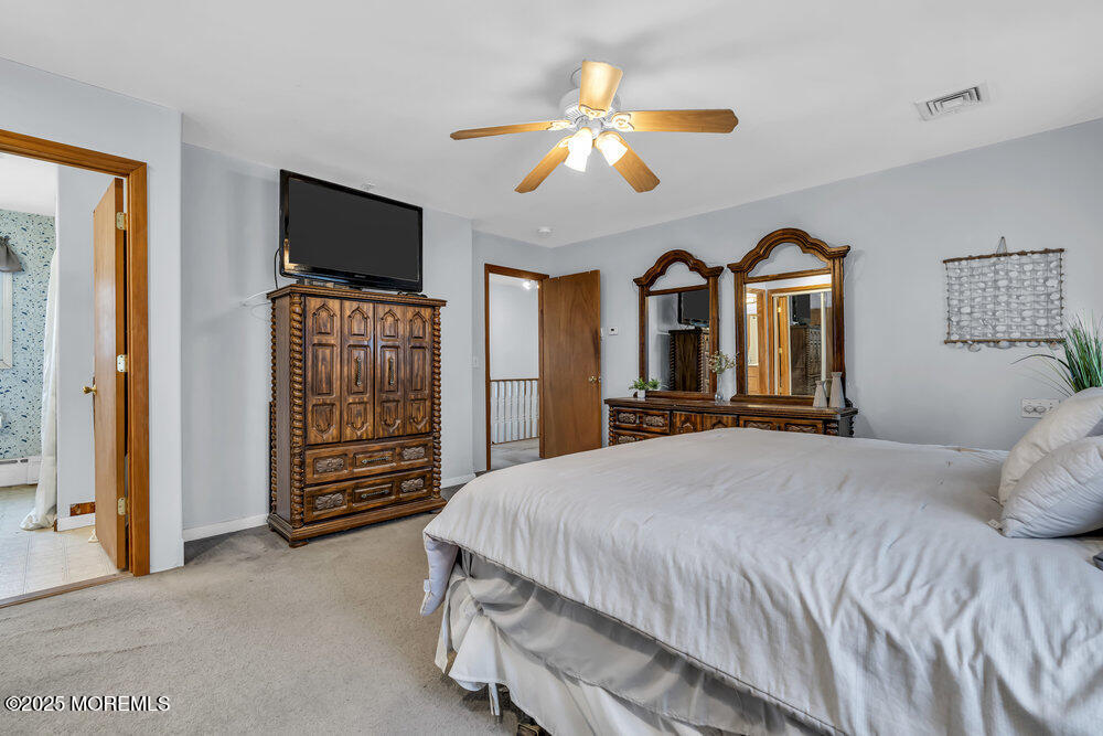 40 Pinehurst Road Brick, NJ 08723 - Photo 36 of 47 a bedroom with a bed and a flat screen tv on dresser