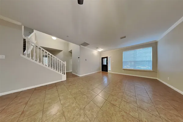 a view of an empty room with stairs